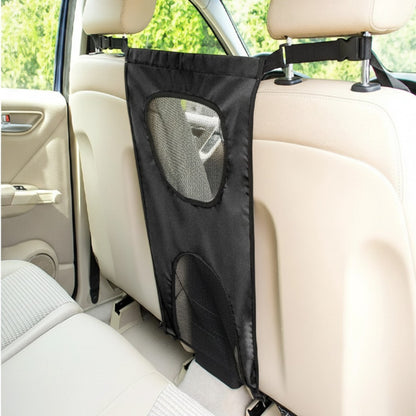 Filet de séparation AventureCanine en nylon noir pour chien, installé entre les sièges avant d'une voiture.